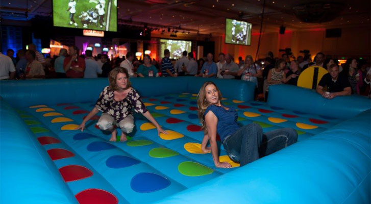 Image: Event attendees have fun playing twister. Themed event development by Benchmarc360.